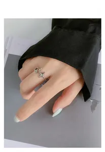Detail of S925 sterling silver meteor ring with green gemstone on hand model
