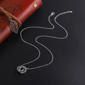 Interlocking double ring necklace in S925 silver with colorful zircon crystals on black background