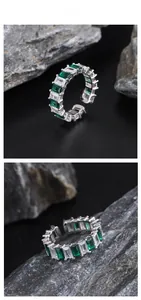 Detail view of S925 silver ring featuring emerald cut green stones and clear zircons