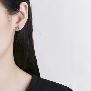 S925 sterling silver vintage star stud earrings with micro-set green zircons on model
