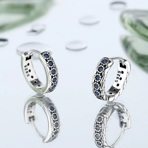 S925 sterling silver braided hoop earrings with blue cubic zirconia on mirror background