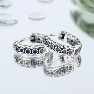S925 sterling silver woven hoop earrings with vintage blue cubic zirconia in macro view
