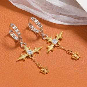 Detail of S925 silver cross earrings with gold fleur-de-lis charms and zircon inlays