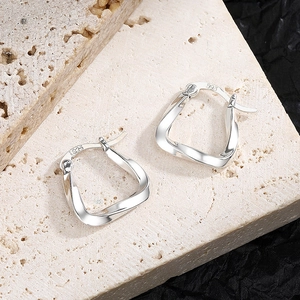 Minimalist S925 sterling silver geometric hoop earrings with a twisted irregular design