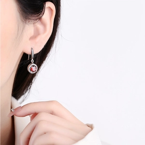 Garnet red round drop earrings with silver 925 hook and halo diamonds on model
