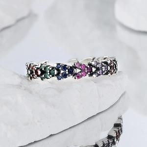 925 silver ring with rainbow zircon stones on white stone with mirror reflection