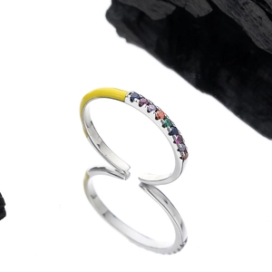 Adjustable S925 silver ring with yellow enamel and multicolored crystals on white background