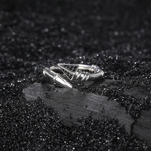925 sterling silver arrow open ring with black pavé stones on a dark textured background