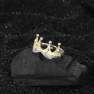Vintage S925 sterling silver crown ring with gold accents on black mineral background