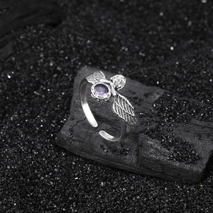 Vintage 925 silver angel wings ring with purple zircon stone on black charcoal