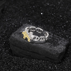 S925 sterling silver puzzle ring with gold contrast texture on black charcoal base