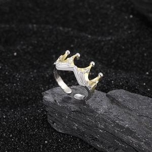 S925 sterling silver crown ring with gold accents on a black stone background