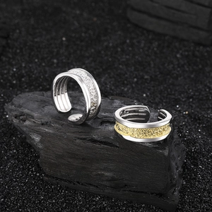 Detailed macro shot of vintage relief patterned rings with gold and silver two-tone contrast