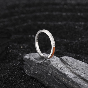 S925 sterling silver open ring with pavé zircons and orange enamel on black rock