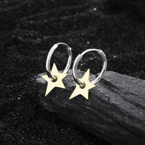 S925 sterling silver hoop earrings with gold star pendants on natural black stone background