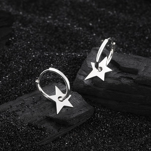 Minimalist S925 sterling silver hoop earrings with hollow star pendants on black stone