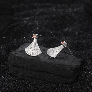 Silver fan-shaped drop earrings with vintage baroque relief and orange gemstone accents