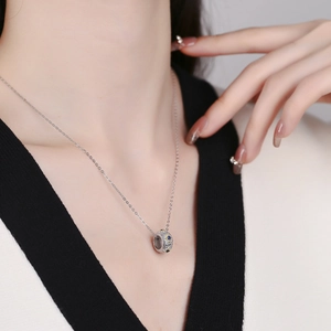 S925 sterling silver cylinder pendant necklace with blue stones on a female model