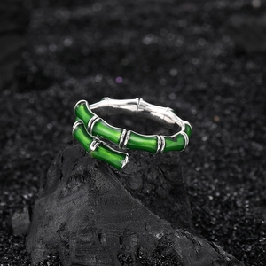 Bamboo style S925 sterling silver ring with green enamel finish on dark volcanic rock