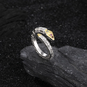 S925 sterling silver snake ring with gold accents and colorful gems on black rock