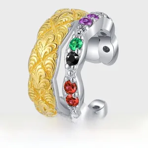 Detail of two-tone S925 silver ear cuff with colorful zircons and engraved gold leaf pattern