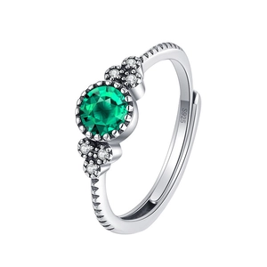 S925 sterling silver ring with central green stone and round side diamonds on white background