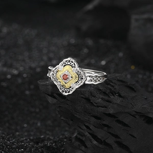 Elegant S925 silver flower ring with gold petals and a central red zircon stone