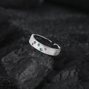 Elegant S925 silver ring with textured finish and colorful zircon stones on dark stone