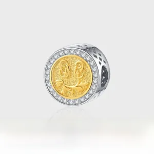 Macro shot of silver and gold charm pendant with smiling face motif and zircon halo