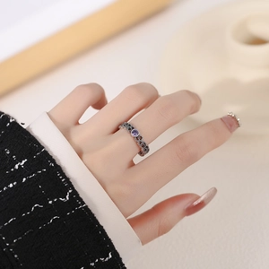 Vintage s925 silver ring with hollow carvings and a round purple gemstone on finger