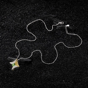 S925 silver star pendant necklace with green gemstone on rustic wood backdrop