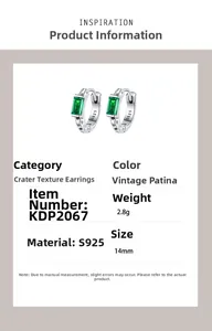 Macro detail of S925 silver earring with crater texture and green zircon stone