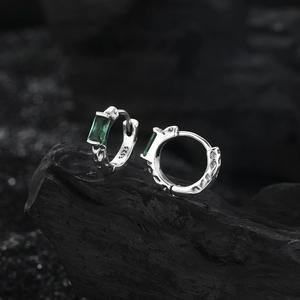 S925 sterling silver hoop earrings with green zircon and crater texture on dark rock