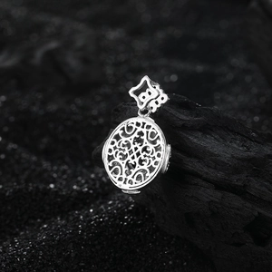 Detailed macro view of S925 sterling silver four-leaf clover pendant with brushed texture