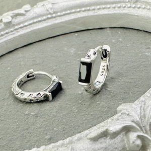 Detail of S925 sterling silver stamp and vintage texture on green zircon earrings