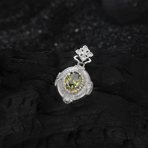Vintage s925 silver four-leaf flower pendant with olive green stone on dark background