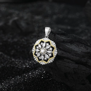 S925 sterling silver snowflake pendant with gold contrast and sparkling diamonds on black stone