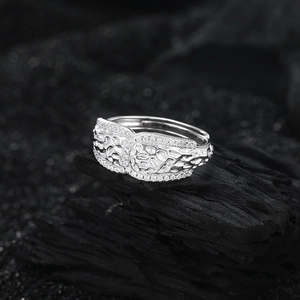 S925 sterling silver ring with rock texture and zircon pavé on a dark stone background