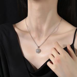 Two-tone s925 silver snowflake pendant necklace with gold hollow frame on female model