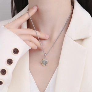 S925 sterling silver heart pendant with emerald stone and gold-plated floral hollow pattern
