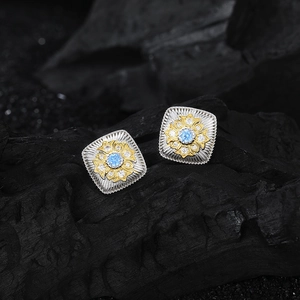 Square S925 silver and gold floral earrings with blue zircon on black charcoal background