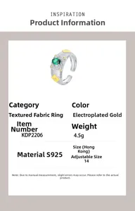 Detailed view of S925 silver ring with woven texture, gold accents and green zircon