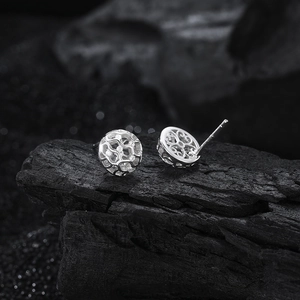 Elegant s925 silver hollow ball stud earrings with sparkling cubic zirconia on charcoal
