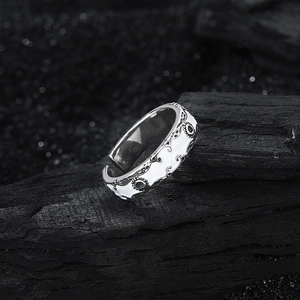 Vintage S925 sterling silver adjustable ring with embossed patterns on charcoal background