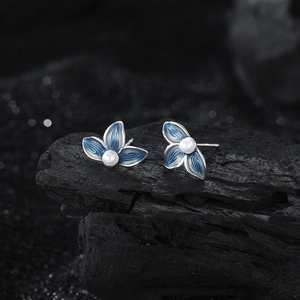 Elegant s925 silver stud earrings with blue enamel petals and a central white pearl