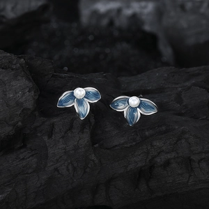 Vintage s925 silver blue enamel flower earrings with white pearls on dark background