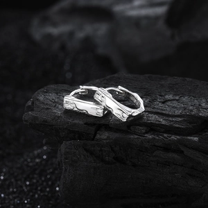Irregular textured S925 sterling silver hoop earrings with micro-set zircon on black charcoal