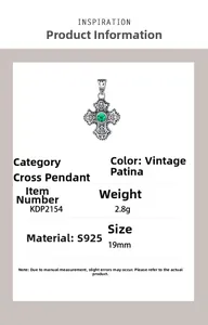 Detail view of S925 sterling silver cross pendant with green gemstone and vintage texture