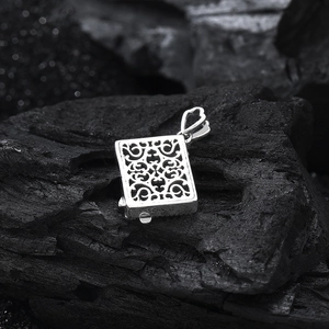 Macro detail of S925 sterling silver stamp on the edge of embossed butterfly pendant
