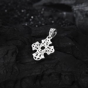 Close-up of vintage S925 silver hollow cross pendant with floral vine carvings